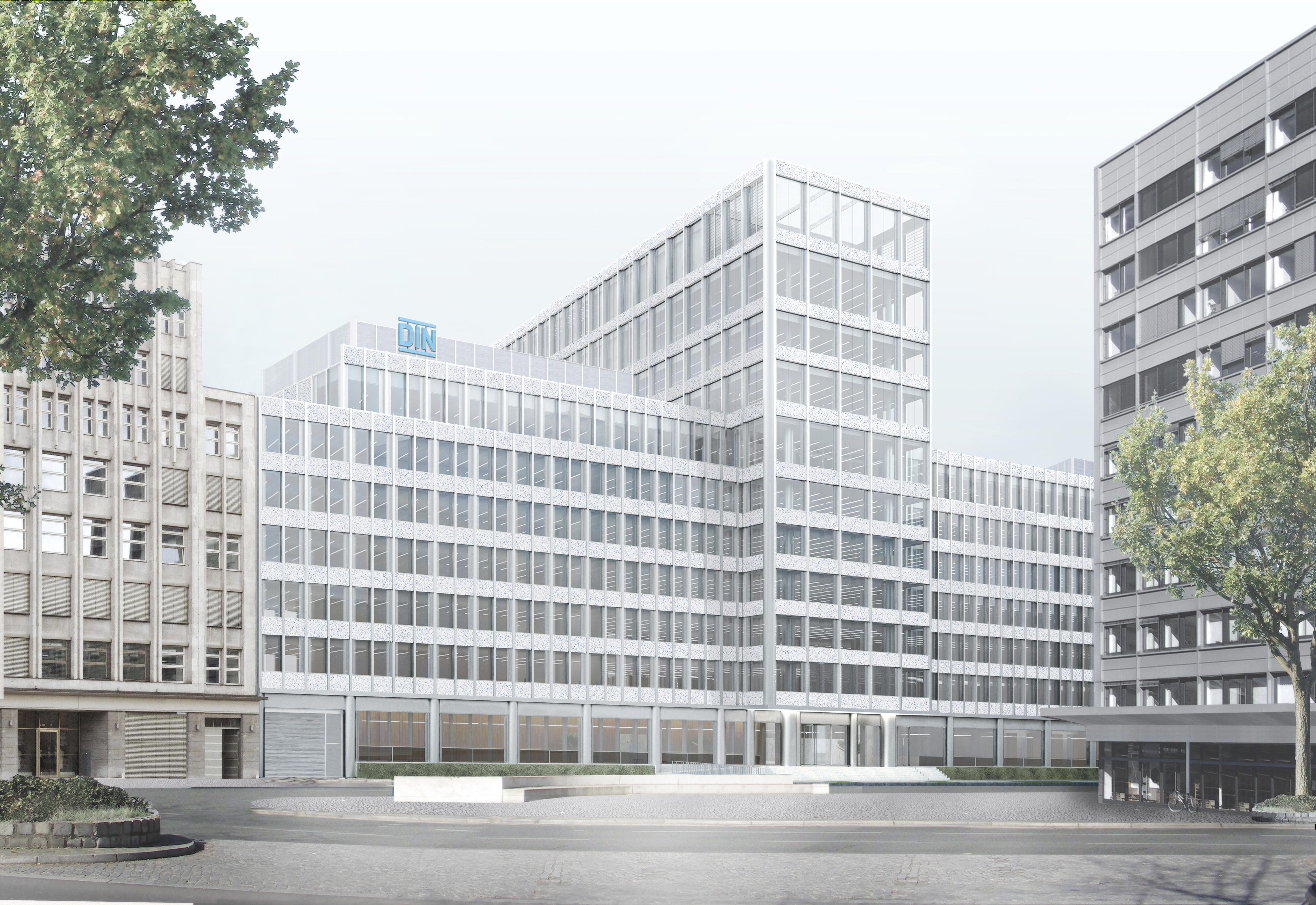 A modern office building with glass facade and DIN logo, surrounded by trees and adjacent structures.